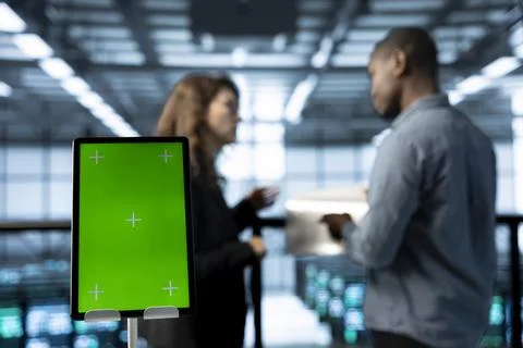 Close up of mockup tablet next to workers in data center using automation tools Stock Photos