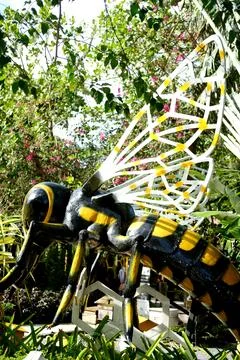 Close-up model of a bee sculpture with black and yellow colors, detailed wings Stock Photos