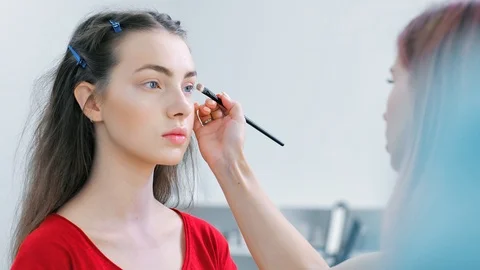 Close-up model face during working of professional female make-up artist Stock Footage 93394816