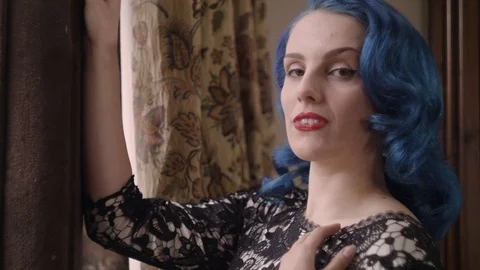 Close up of model looking out window seductively Stock Footage 109488427