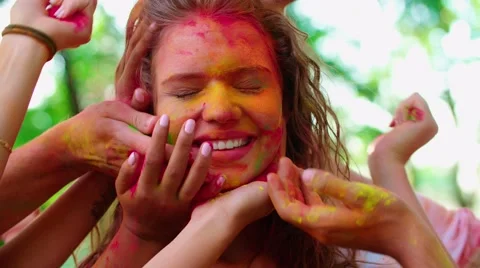 Close-up of the model many hands stain the face of your friends with colors of Video stock 67756574