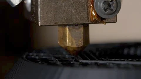 Close up of a modern 3D printer. Head of 3d printer in action. Close Up Of 3D Stock Photos