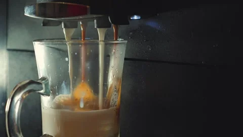 A close-up a modern automatic coffee machine dispensing hot espresso Stock Footage 346471807
