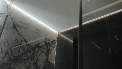 Close-up of a modern bathroom ceiling with a stunning black marble backsplash Stock Footage 311252279