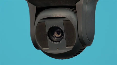 A close up of a modern black surveillance camera turning against a bright sky Stock Footage 320520861