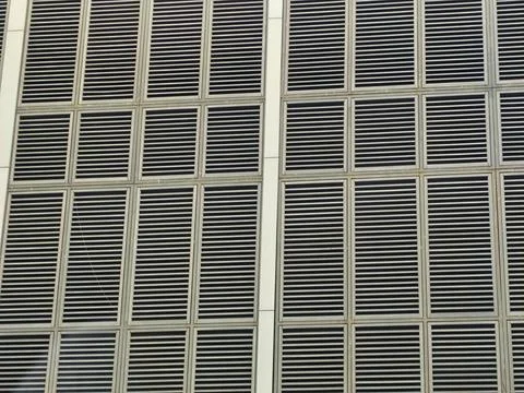 Close-up of a modern building facade featuring uniform ventilation grilles in Фото