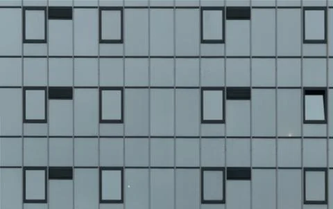 Close up of a modern building facade with repeating windows. A geometric Foto stock