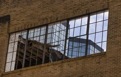 Close up of a modern building seen through an old building Stock Photos