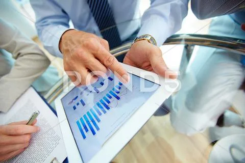 Close-up of a modern business team using tablet computer to work with financial Stock Photos