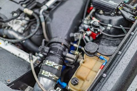 Close-up of modern car engine bay showcasing intricate components Stock Photos
