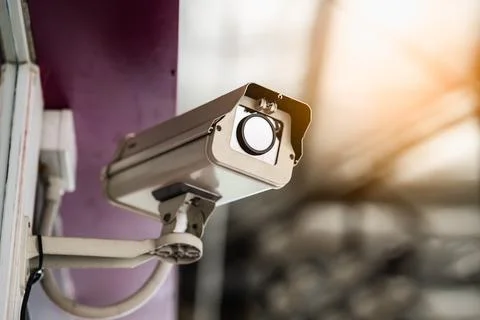 Close up of modern CCTV camera on a wall. Concept of surveillance and monitor Stock Photos