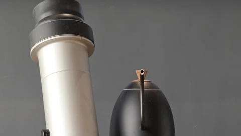 Close-up of modern coffee brewing equipment against muted gray studio background Stock Footage 344746762