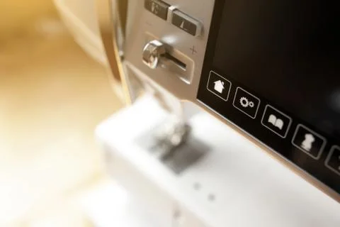 Close up of modern computerised sewing machine in bright sunny light Stock Photos