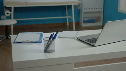 Close up of modern desk in empty doctors office Stock Footage 158613390