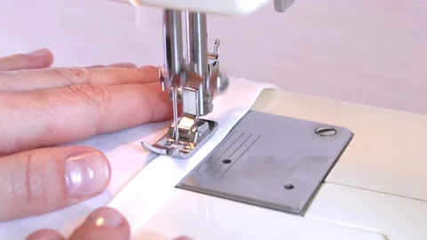 Close-up of a modern electric sewing machine sewing together a piece of textile Stock Footage 217442374