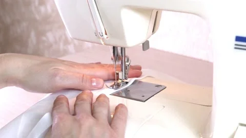 Close-up of a modern electric sewing machine sewing together a piece of textile Stock Footage 217442511