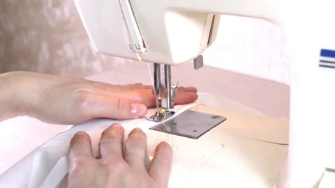 Close-up of a modern electric sewing machine sewing together a piece of textile Stock Footage 217442529