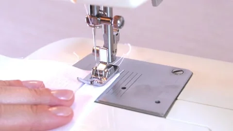 Close-up of a modern electric sewing machine sewing together a piece of textile Stock Footage 217442567
