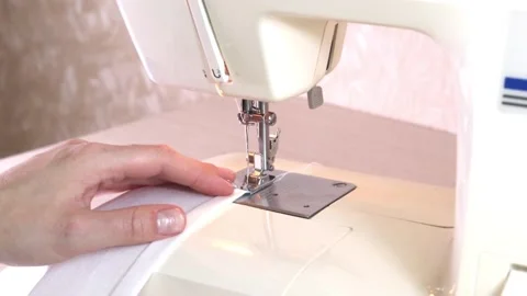 Close-up of a modern electric sewing machine sewing together a piece of textile Stock Footage 217442677