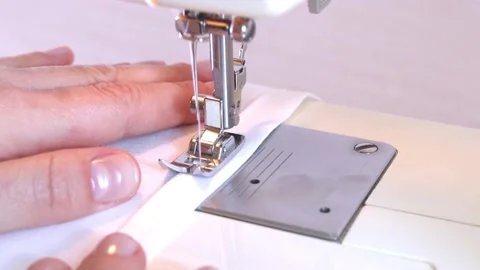 Close-up of a modern electric sewing machine sewing together a piece of textile Stock Footage 217442796