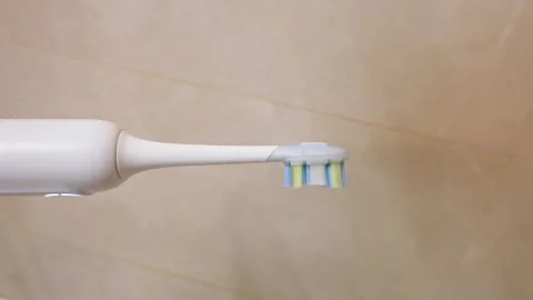 Close Up of Modern Electric Toothbrush with Vibrating Colored Bristles Stock Footage 340068261