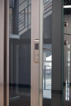 Close-up of Modern Elevator Control Panel and Glass Door Stock Photos