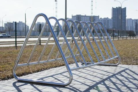Close-up of a modern, empty silver stainless steel bicycle parking rack loc.. Stock Photos