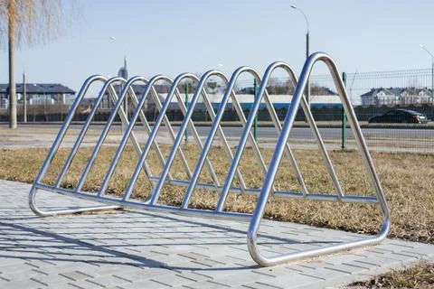 Close-up of a modern, empty silver stainless steel bicycle parking rack loc.. Stock Photos