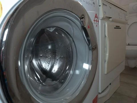 Close-up of a Modern Front-Loading Washing Machine in a Bathroom Stock Photos