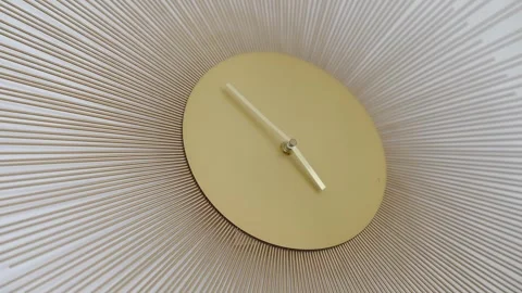 Close Up of Modern Golden Clock with Radiating Linear Patterns Stock Footage 308809675