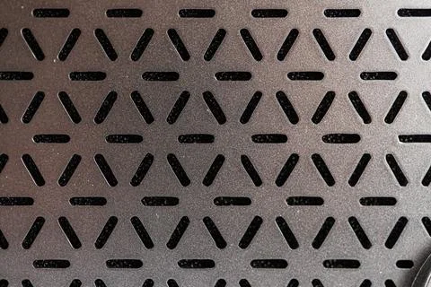 Close-up of a modern, gray-scale mini guitar amplifier speaker with an intric Stock Photos