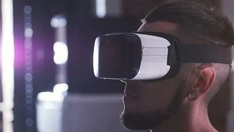 Close-up of modern guy in virtual reality headset. Portrait of student using new Stock Footage 98179228
