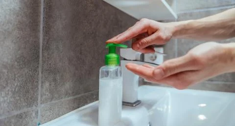 Close up. modern guy washes his hands in the bathroom. Stock Photos
