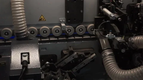 Close-up of a modern machine for gluing seams from particleboard, furniture fact Stock Footage 120872580