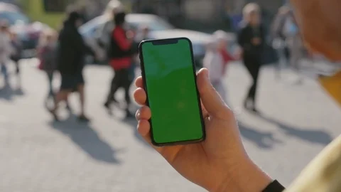 Close-up of modern man showing vertical smartphone mock-up greenscreen making Stock Footage 117428259