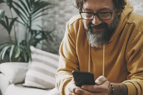 Close up of modern man using mobile phone application having fun and smiling. Stock-Fotos