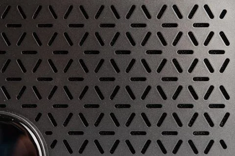 Close-up of a modern mini guitar amplifier speaker with geometric honeycomb.. Stock Photos