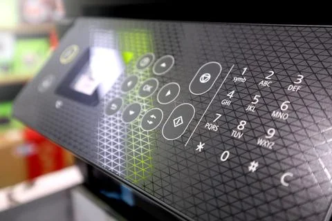 Close-up of a modern printer control panel featuring a numeric keypad, geom.. Stock Photos