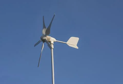 Close up of modern rotating anemometer on top of a pole with deep blue sky Stock Photos