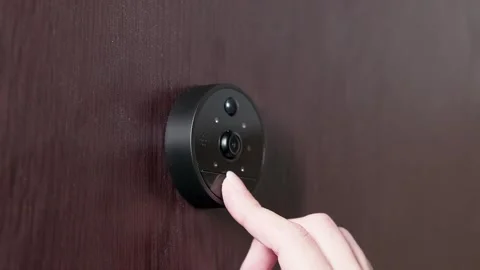 Close-Up of Modern Smart Doorbell with Camera Being Pressed on Dark Wooden .. Stock Footage 309823815
