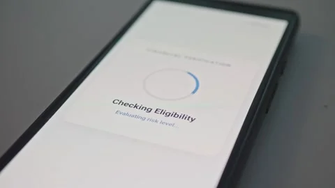 Close-up of modern smartphone lying on a carpet showing loan eligibility check Stock Footage 341569712