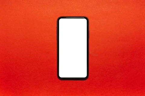 Close-up of modern smartphone with white empty mockup on lush lava background.  Stock Photos