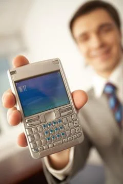 Close-up of modern technological device held by successful man Stock Photos