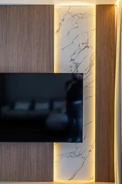 Close-up of modern TV wall unit with marble and wood panels Fotos de archivo