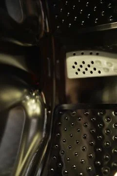 Close-Up of Modern Washing Machine Drum Interior with Metallic Finish Stock Photos