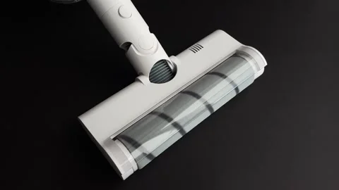 Close up of a modern white cordless vacuum cleaner nozzle. The brush roll spins  Stock Footage 340194569