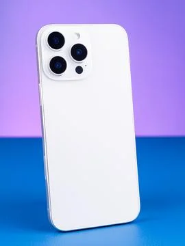 Close-up of modern white  smartphone with three cameras  on purple background Stock Photos