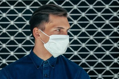 Close up. a modern young man in a protective mask Stock Photos
