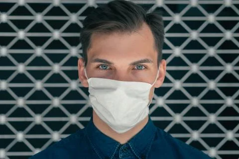 Close up. a modern young man in a protective mask Stock Photos