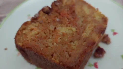 Close-up of moist carrot cake slice with nuts on a plate Stock Footage 333642987